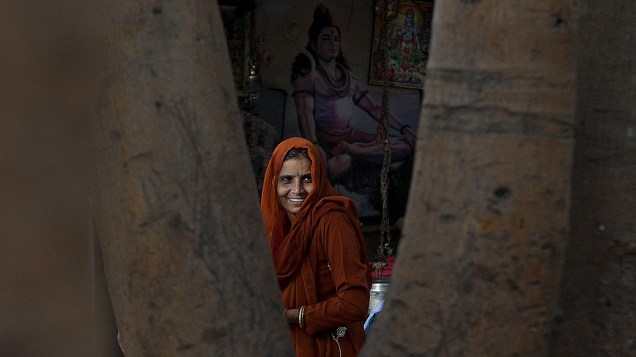 Devota hindu caminha em templo após rezar no rio Yamuna, em Nova Délhi, capital da Índia