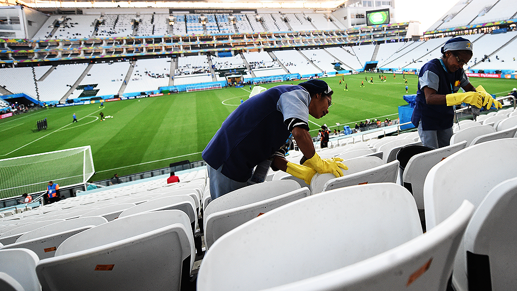Funcionários limpam as cadeiras do Itaquerão antes da abertura da Copa, em São Paulo