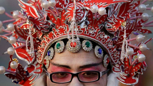 Homem aguarda para se apresentar em celebração do Festival das Lanternas em Zhengding, China