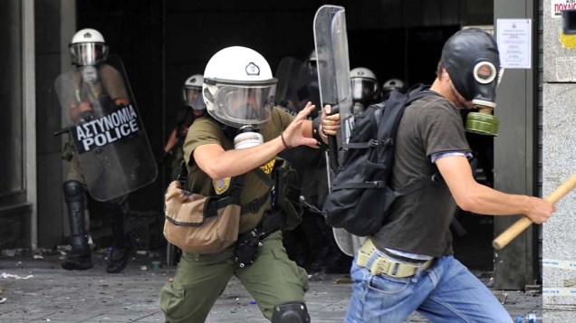 Manifestante em conflito com a polícia no centro de Atenas, Grécia, na quarta-feira, 15 de junho