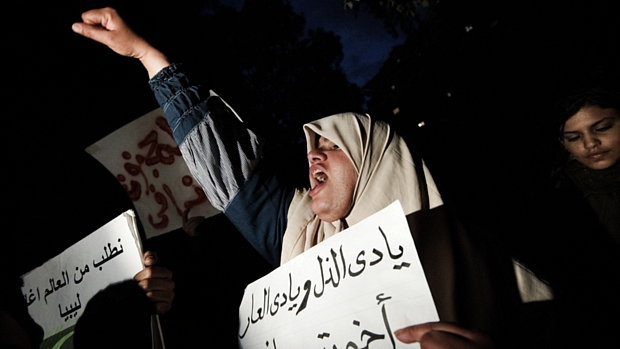 Manifestantes gritam slogans contra o ditador Kadafi