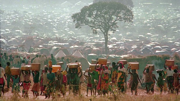 Refugiados carregam água a caminho de um campo de refugiados na Tanzânia, na fronteira com Ruanda, em 1994