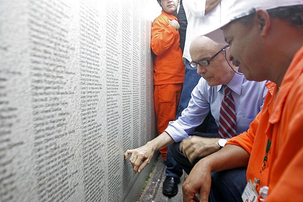 O governador José Serra observa painel com os nomes de todos os operários que participaram da obra do Rodoanel