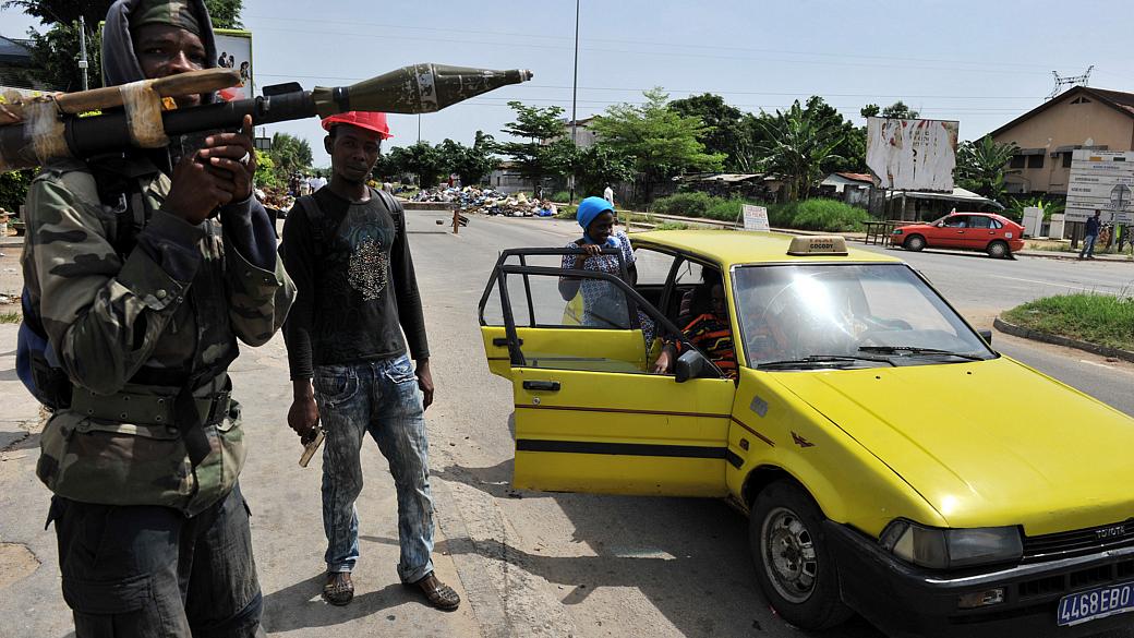 Soldado leal ao presidente eleito da Costa do Marfim, Alassane Ouattara, segura um lançador de granadas numa rua de Abidjan, nesta segunda-feira
