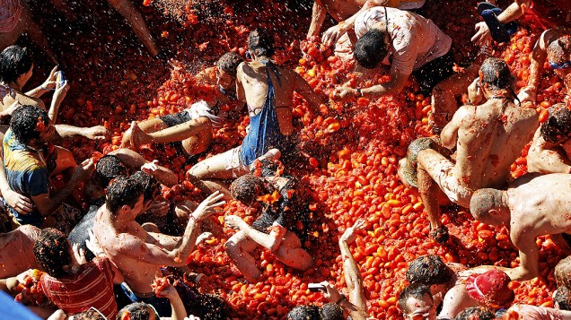 Foliões lotam as ruas da vila de Buñol, em Valência (Espanha), para participar da festa da Tomatina