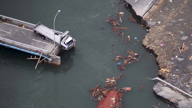 Caminhão pendurado em uma ponte que desabou em Ishinomaki, após terremoto e tsunami que atingiram o Japão