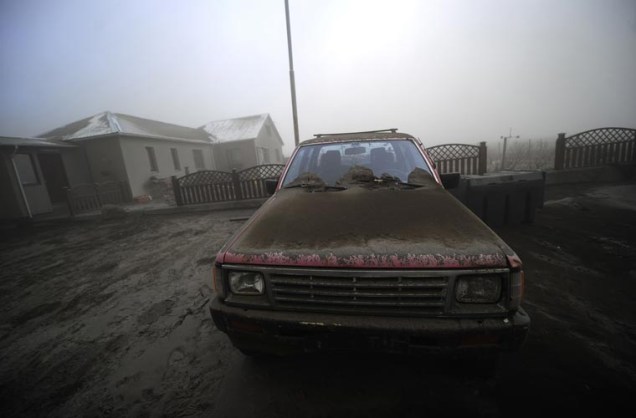 Cinzas do vulcão cobrem um carro que foi deixado em uma fazenda na Islândia. Região precisou ser evacuada.
