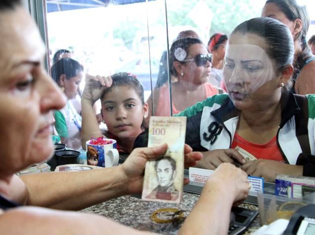 Cidadãos venezuelanos trocam dinheiro em uma casa de câmbio em Villa del Rosario perto de Cucuta, na Colômbia - 10/07/2016