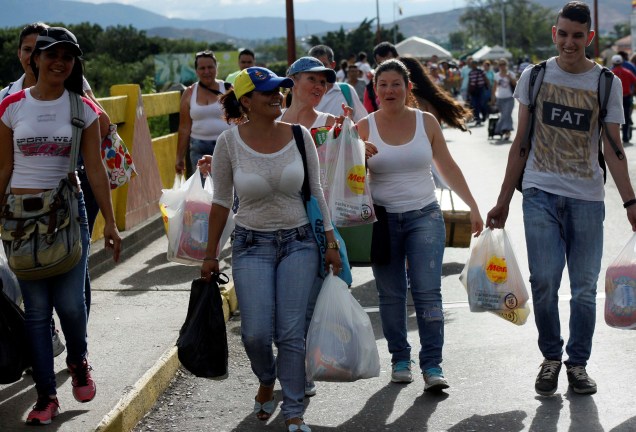 Venezuelanos carregam sacolas de mantimentos após aproveitarem a abertura temporária de fronteira com a Colômbia para fazer compras no país vizinho - 10/07/2016