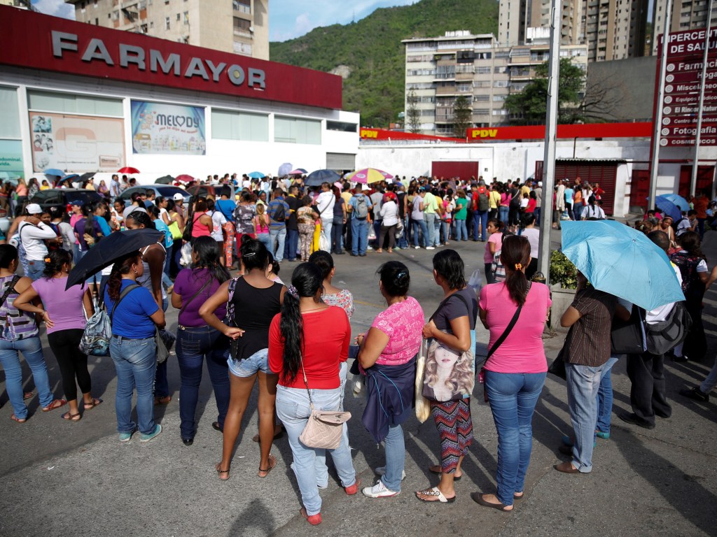 Pessoas tentam comprar papel higiênico e fraldas em uma farmácia em Caracas, na Venezuela