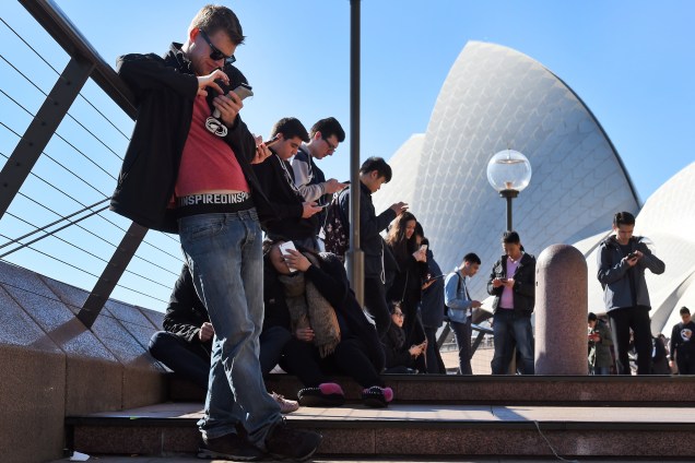 Dezenas de pessoas jogam 'Pokémon Go' - game de realidade aumentada desenvolvido pela Nintendo -  próximas ao Opera House, em Sydney, na Austrália - 15/07/2016