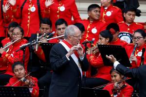 Peru's President Pedro Pablo Kuczynski plays the flute during the ministers swearing in ceremony at the Government Palace in Lima, Peru, July 28, 2016. REUTERS/Guadalupe Pardo