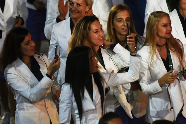 Garotas registram a abertura dos Jogos Olímpicos com fotos de celular, no estádio do Maracanã, Rio de Janeiro