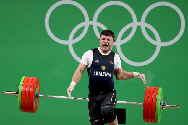 O atleta Andranik Karapetyan da Armênia quebra o braço durante disputa no levantamento de peso na categoria até 77Kg