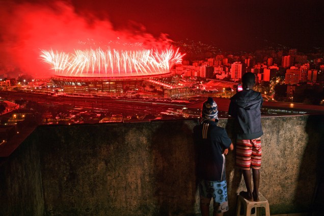 Crianças assistem da favela da Mangueira o show de fogos de artifício no Maracanã durante a cerimônia de encerramento da Rio-2016