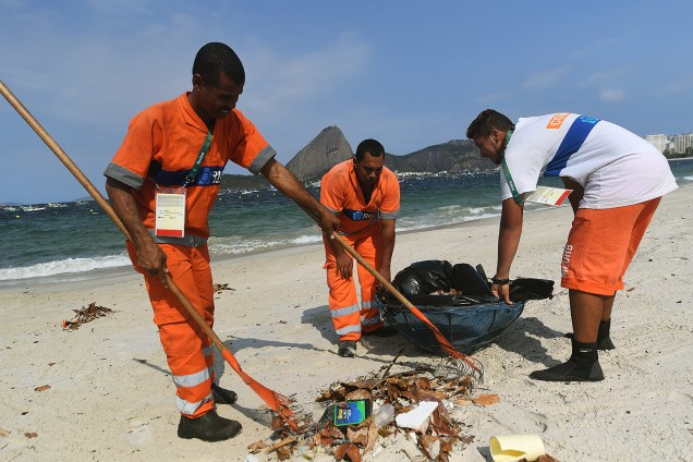 Garis recolhem o lixo da praia do Flamengo, no Rio de Janeiro