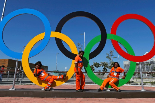 Funcionárias posam em frente aos anéis, símbolos da Olimpíada, no Parque Olímpico do Rio de Janeiro - 01/08/2016