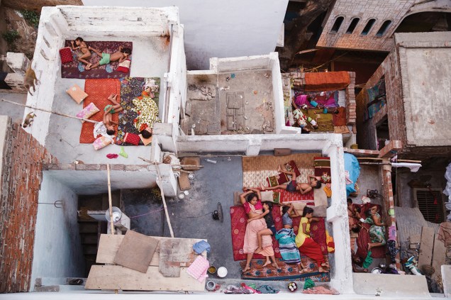 Fotógrago registra família dormindo nos telhados de suas casas, em Varanasi, na Índia