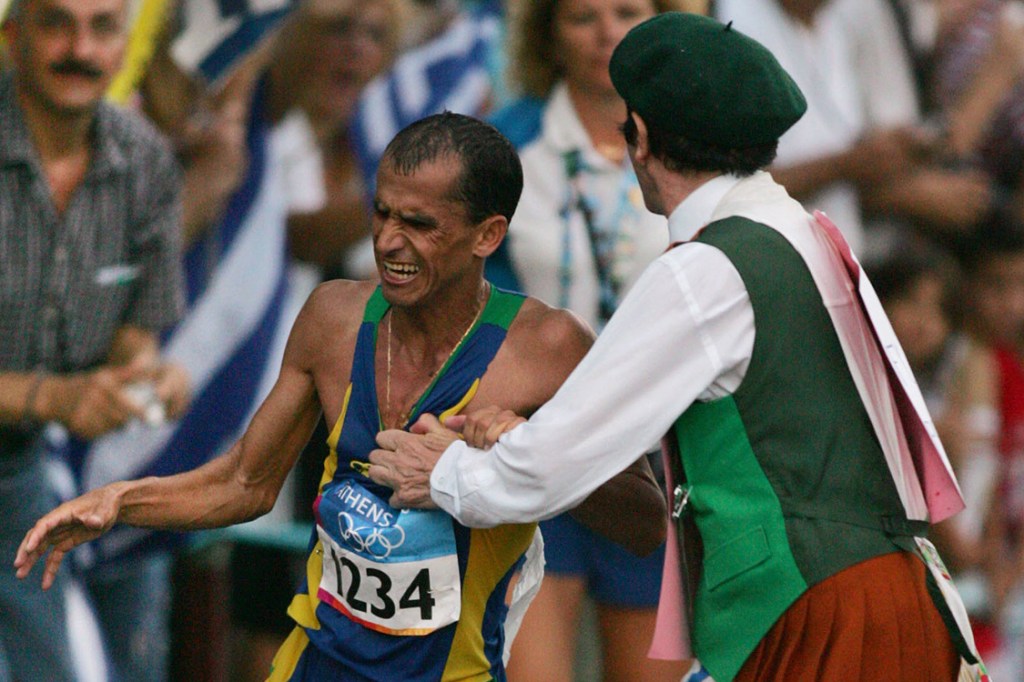 Vanderlei Cordeiro é empurrado para fora da pista por um homem fantasiado de padre irlandês durante competição nos Jogos Olímpicos de Atenas em 2004
