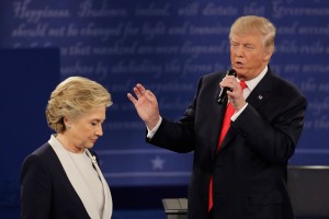 Democratic presidential nominee Hillary Clinton walks past Republican presidential nominee Donald Trump during the second presidential debate at Washington University in St. Louis, Sunday, Oct. 9, 2016. (AP Photo/Patrick Semansky)