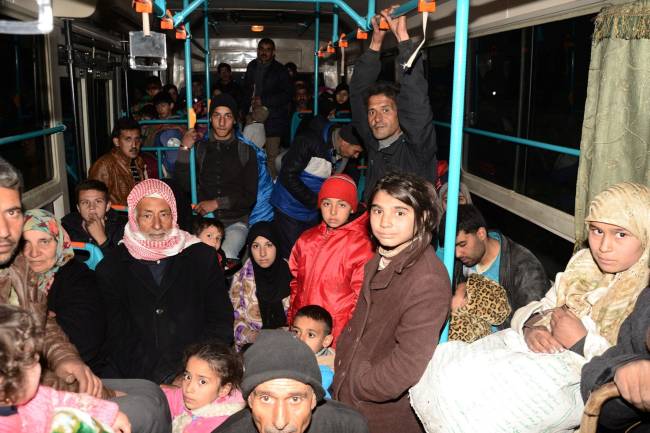 Syrians who evacuated the eastern districts of Aleppo ride a government bus in Aleppo, Syria in this handout picture provided by SANA on November 27, 2016. SANA/Handout via REUTERS ATTENTION EDITORS - THIS IMAGE WAS PROVIDED BY A THIRD PARTY. EDITORIAL USE ONLY. REUTERS IS UNABLE TO INDEPENDENTLY VERIFY THIS IMAGE.