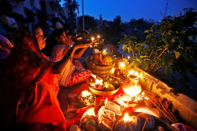 Devotos hindus seguram velas em adoração à divindade do sol 'Surya', no festival religioso 'Chhath Puja, em Calcutá, na Índia - 07/11/2016