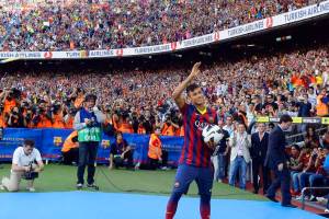 Neymar waves to Barcelona’s supporters at his presentation after signing a five-year contract with the club, at Nou Camp stadium in Barcelona