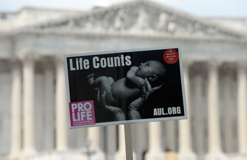 WASHINGTON, DC - JULY 28: Anti-abortion activist sign is held aloft during a rally opposing federal funding for Planned Parenthood in front of the U.S. Capitol on July 28, 2015 in Washington, DC. Sen. Rand Paul (R-KY)  announced a Senate deal to vote on legislation to defund Planned Parenthood before the Senate goes into recess in August. (Photo by Olivier Douliery/Getty Images)