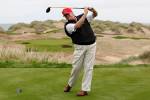 U.S. property magnate Donald Trump practices his swing at the 13th tee of his new Trump International Golf Links course on the Menie Estate near Aberdeen, Scotland, Britain June 20, 2011. To match Special Report USA-ELECTION/TRUMP-GOLF REUTERS/David Moir/File Photo