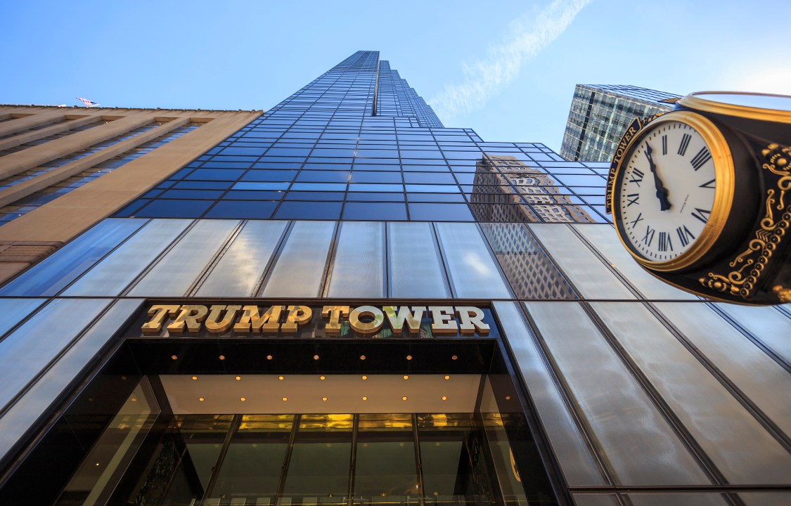 New York City, United States - March 12, 2016: Looking up at the 5th avenue Trump Tower with the gold name and clock in sight