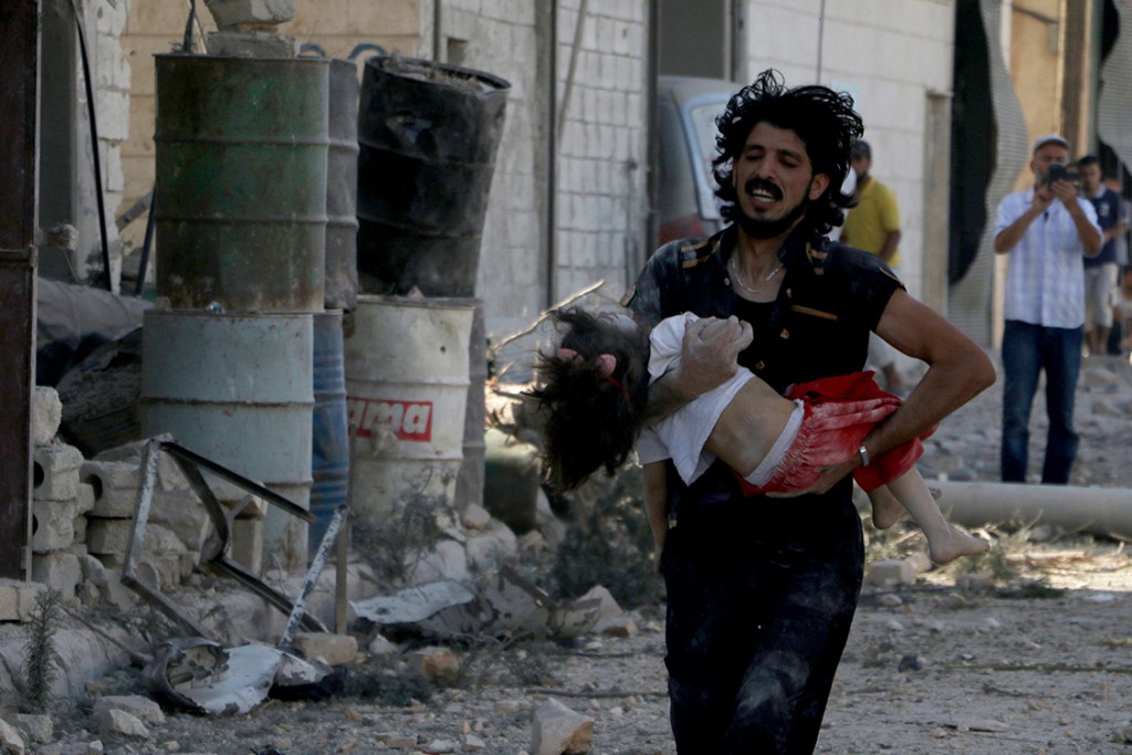 Feridos e mortos são evacuados após bombardeio das forças de Bashar Assad no bairro Sahur, controlado pela oposição, na cidade de Aleppo, na Síria, em julho de 2016 (Crédito Ibrahim Ebu Leys/Anadolu Agency/Getty Images)