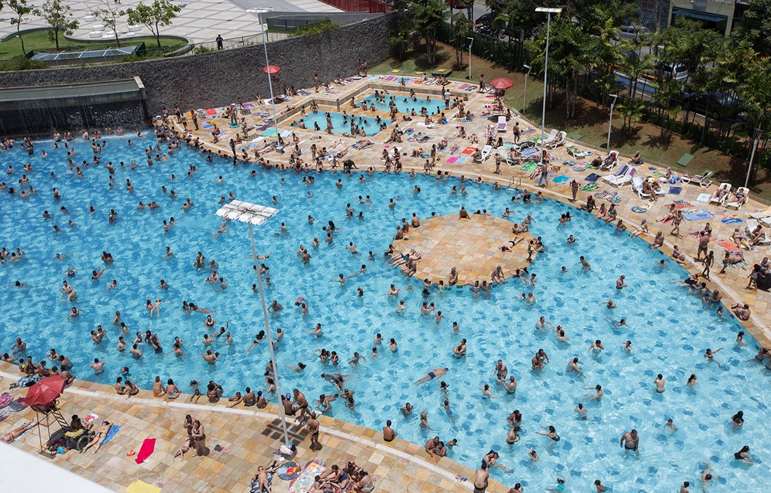 Sócios, credenciários e comerciários frequentam a piscina do SESC Belenzinho, em São Paulo, após um dia quente de verão