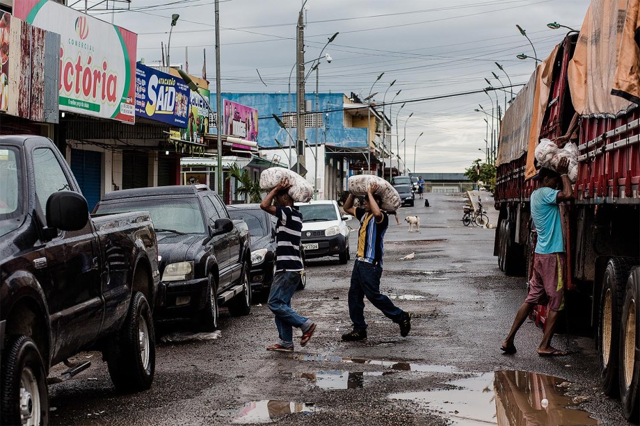 Venezuelanos descarregam caminhão vindo de Boa Vista com mantimentos para abastecer o comércio local, no centro de Pacaraima. A maioria dos compradores são familias e comerciantes venezuelanos.