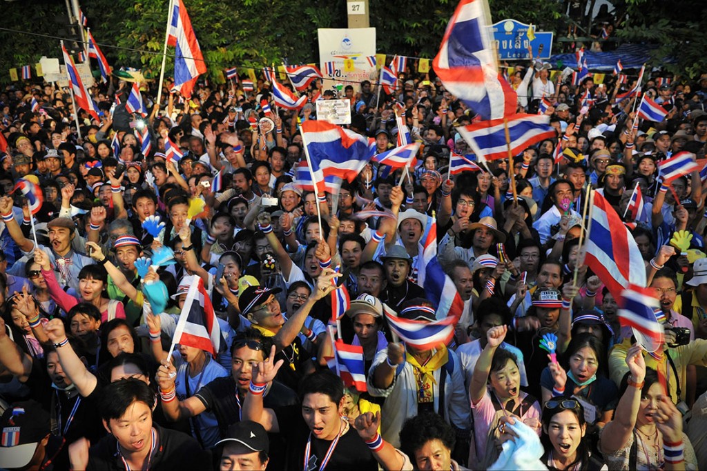 BANGKOK, THAILAND - DECEMBER 9: Anti-government protesters react to a speech by former Democrat Party MP and anti-government protest leader Suthep Thaugsuban during a large rally near Government House on December 9, 2013 in Bangkok, Thailand. In his speech Mr Suthep said the public had seized power, while the government led by the Pheu Thai Party dissolved parliament earlier in the day in an attempt to end the political impasse. Tens of thousands of anti-government protesters converged around Government House as new broke of the dissolution of parliament. (Photo by Rufus Cox/Getty Images)