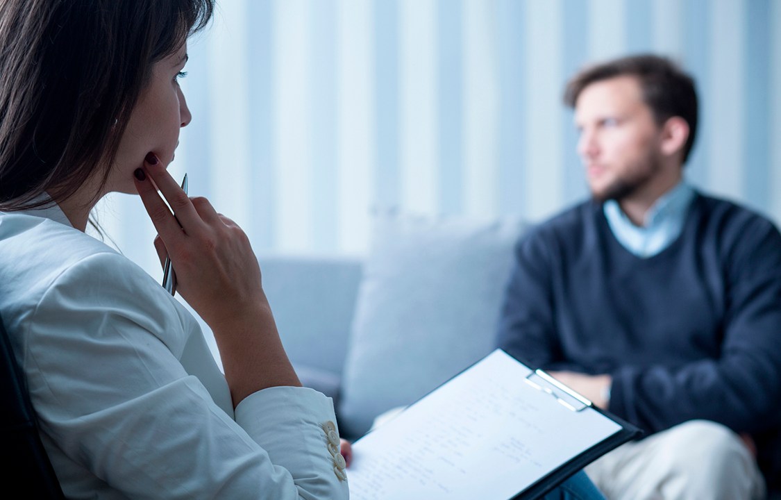 Female psychiatrist talking with patient