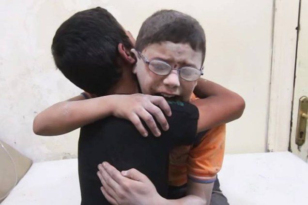Irmãos sírios choram ao se reencontrar em um hospital e saber da morte de outro irmão após bombardeio na cidade de Aleppo