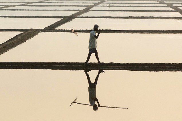 Trabalhador carrega pá de madeira em um campo de Mumbai, na Índia - 16/01/2017