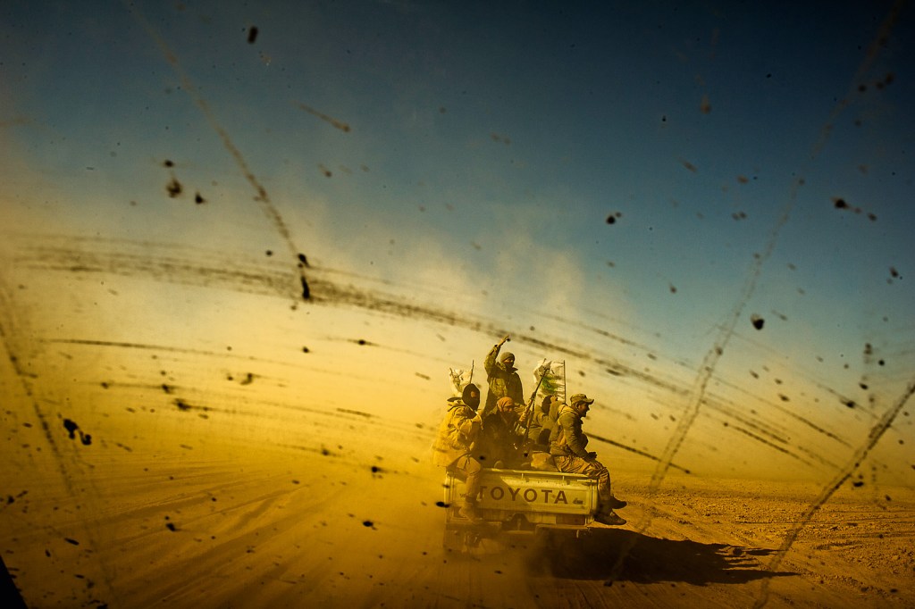 RUMO AO FRONT - Membros das milícias xiitas ao cruzar o deserto para interceptar os combatentes do EI que tentam fugir para a Síria
