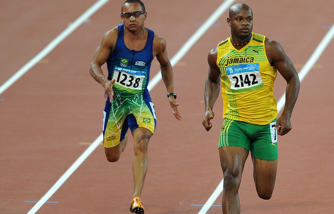 Walter Dix of the US (L), Brazil's Vicente Lima and Jamaica's Asafa Powell compete during the men's 100m round 2 heat 5 at the National stadium as part of the 2008 Beijing Olympic Games on August 15, 2008. Jamaica's Asafa Powell won ahead of Bahamas' Derrick Atkins and Walter Dix of the US. AFP PHOTO / WILLIAM WEST / AFP PHOTO / WILLIAM WEST