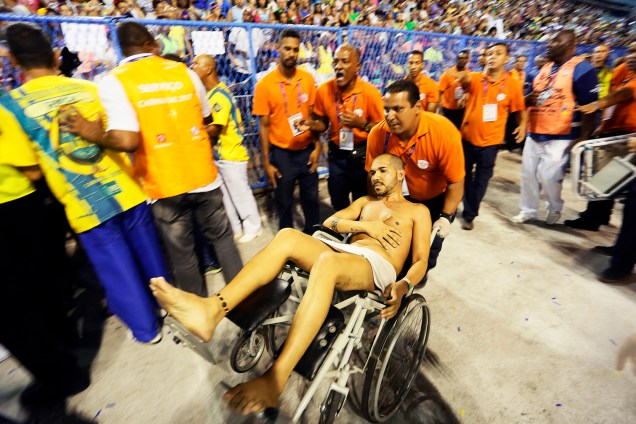 Ferido é transportado em cadeira de rodas após estrutura de carro alegórico despencar, no início do desfile da Unidos da Tijuca - 28/02/2017