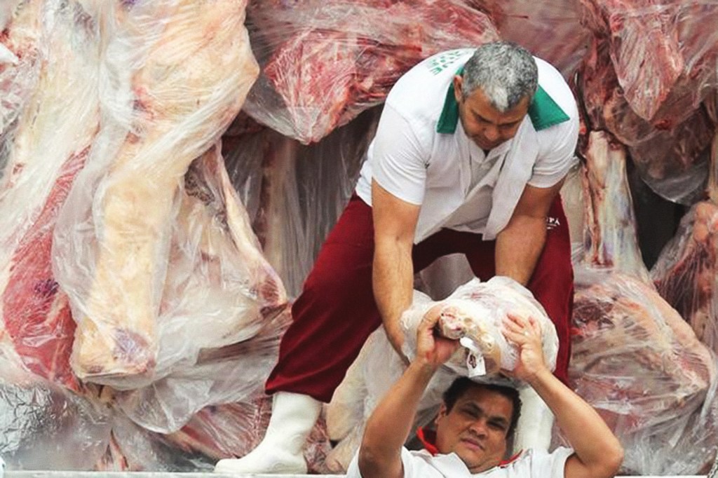 Funcionários descarregam carga de carne em São Paulo