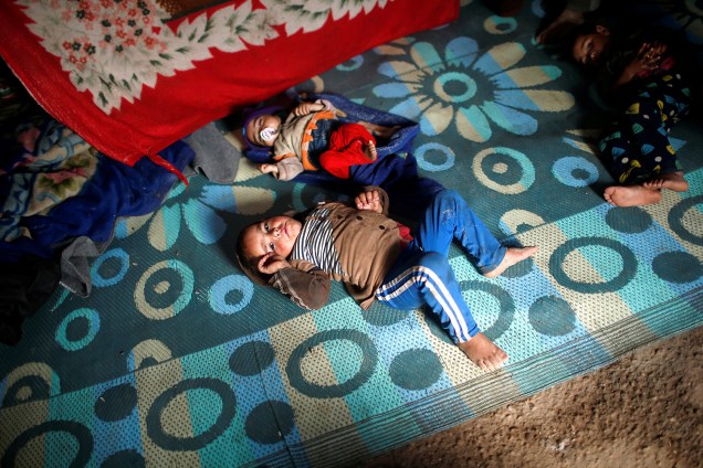 Crianças iraquianas refugiadas deitam no chão de uma tenda no campo Hammam al-Alil, em Mossul - 29/03/2017