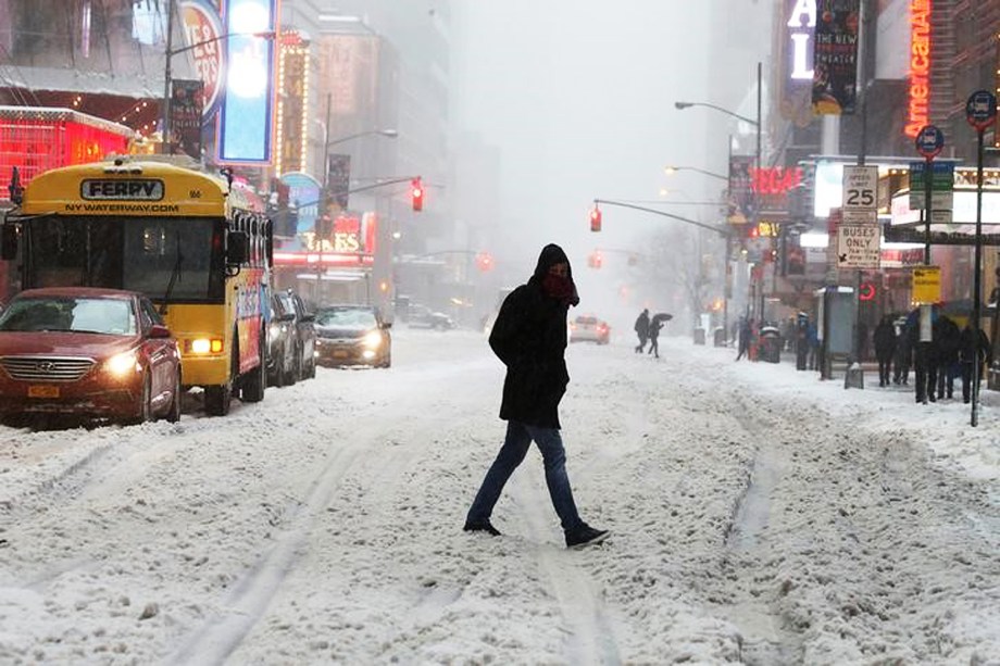 Pedestre atravessa a rua coberta por uma camada de neve em Manhattan, Nova York. A maior parte da costa leste americana está sob alerta de nevasca - 14/03/2017