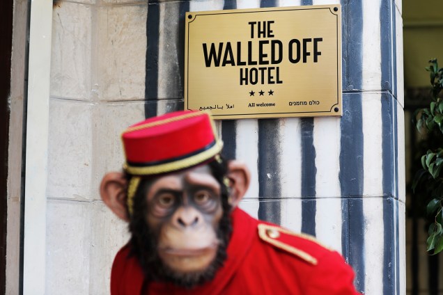 Boneco de mensageiro de hotel em forma de macaco na entrada do Walled Off, recém-inaugurado pelo artista britânico Banksy - 03/03/2017