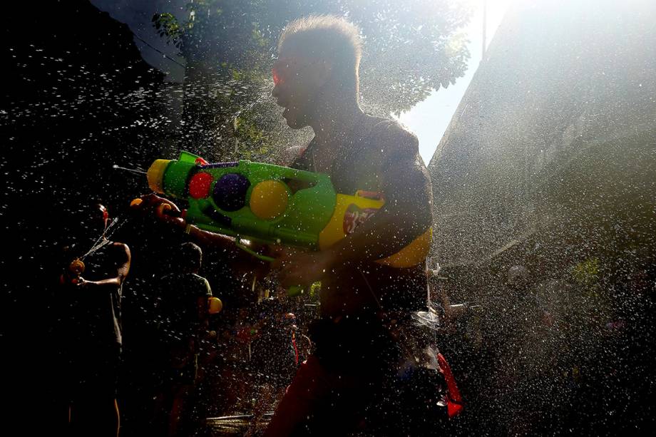 Foliões participam de uma "guerra" de água, durante o festival Songkran em Bangcoc, Tailândia