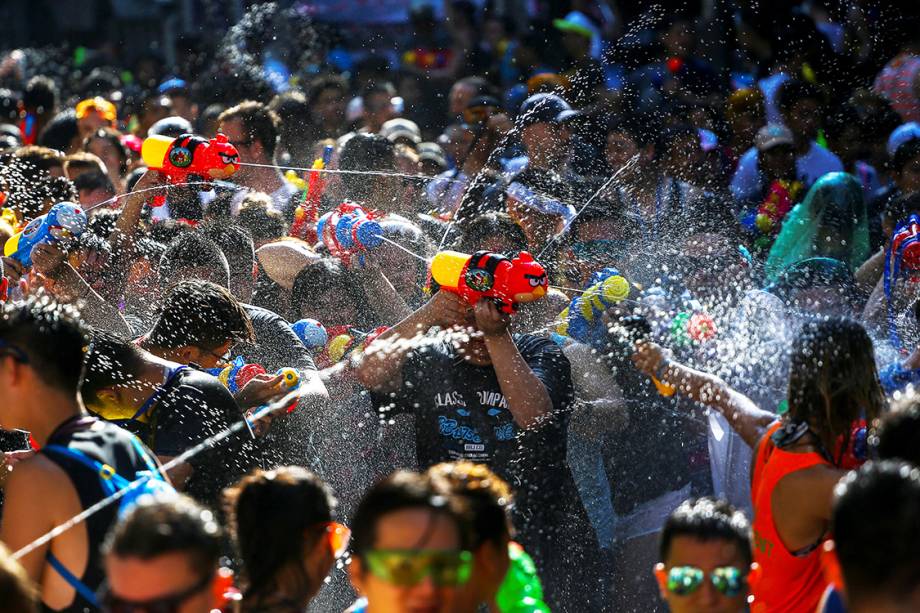 Foliões participam de uma "guerra" de água, durante o festival Songkran em Bangcoc, Tailândia