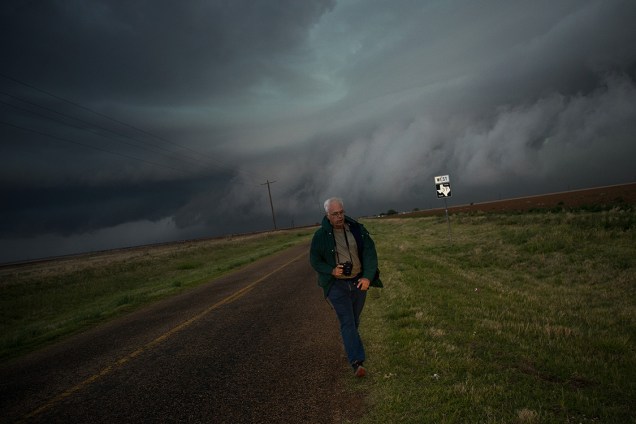 O veterano em perseguir tempestades, Tim Marshall de 40 anos, caminha de volta em direção a equipe enquanto um "supercélula" se forma ao fundo, no Texas