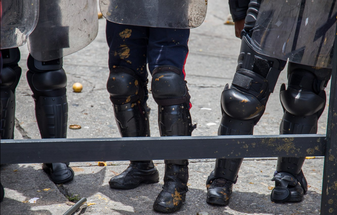 Durante protesto contra o governo venezuelano, manifestantes jogam excrementos nos policiais, em Caracas