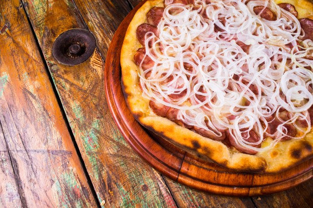 A clássica pizza de calabresa faz sucesso na melhor pizzaria por VEJA COMER & BEBER