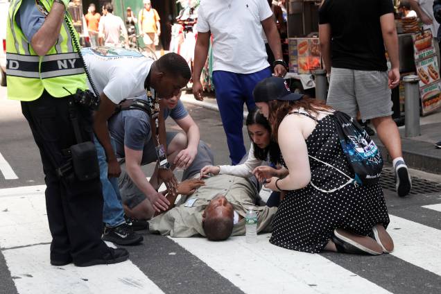 Socorristas e voluntários ajudam feridos depois que um veículo atingiu pedestres em uma calçada na Times Square, em Nova York - 18/05/2017 Socorristas e voluntários ajudam feridos depois que um veículo atingiu pedestres em uma calçada na Times Square, em Nova York - 18/05/2017